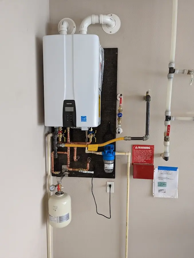 Professional plumber installing copper piping in a Lakeview home